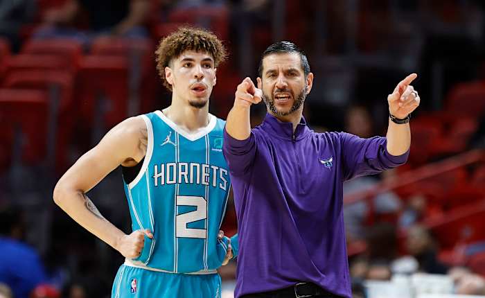 Charlotte Hornets guard LaMelo Ball (2) and head coach James Borrego talk during a time out in the first half against the Miami Heat at FTX Arena.